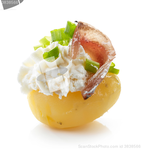 Image of boiled potato decorated with cream cheese, anchovy and spring on