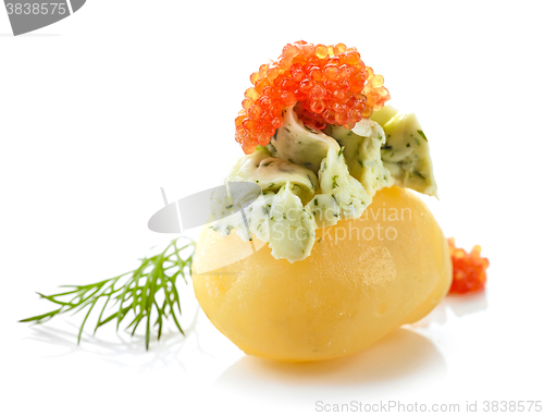 Image of boiled poato decorated with green butter and red caviar