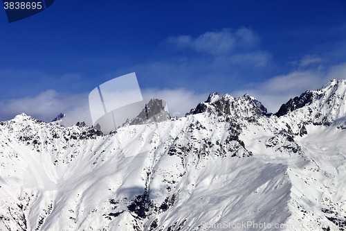Image of View on snowy mountains at sun day