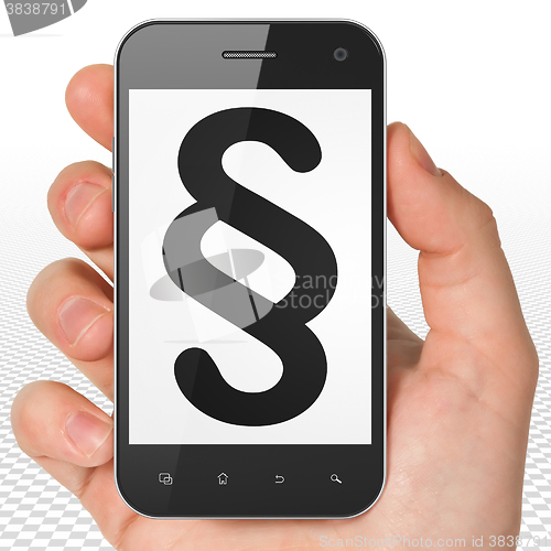 Image of Law concept: Hand Holding Smartphone with Paragraph on display