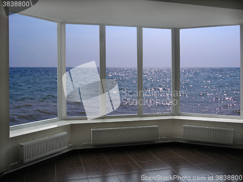 Image of big office windows with view of marine waves