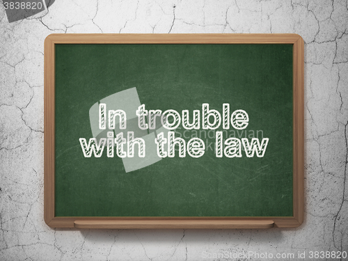 Image of Law concept: In trouble With The law on chalkboard background