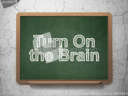 Image of Studying concept: Turn On The Brain on chalkboard background