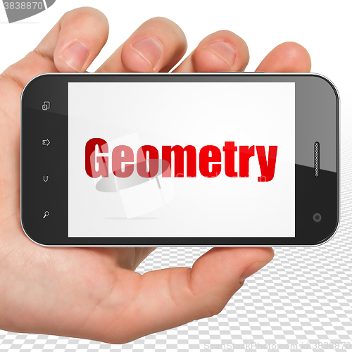 Image of Studying concept: Hand Holding Smartphone with Geometry on display