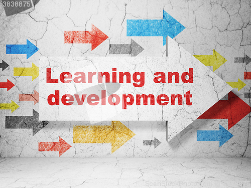 Image of Education concept: arrow with Learning And Development on grunge wall background