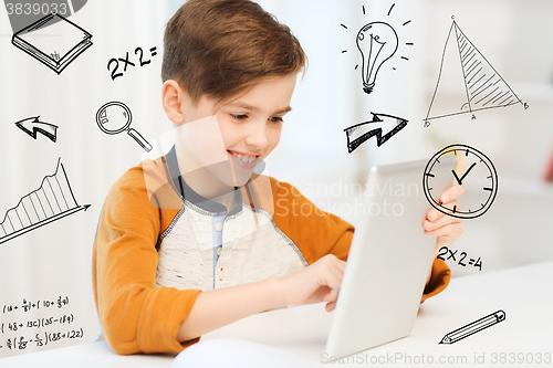 Image of smiling boy with tablet pc computer at home