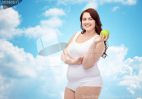 Image of happy plus size woman in underwear with apple