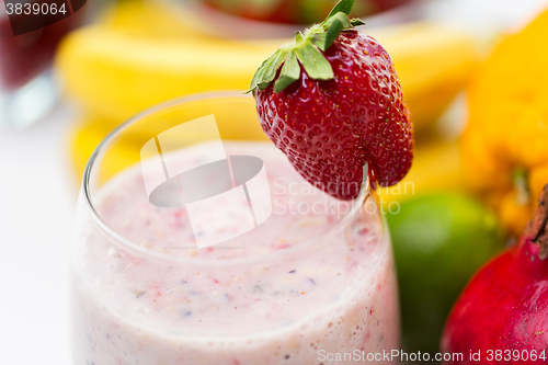 Image of close up of glass with milk shake and fruits