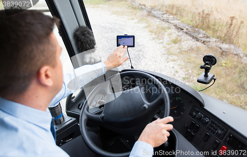 Image of close up of bus driver driving with gps navigator