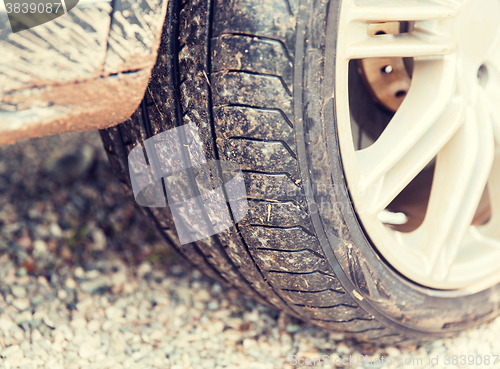 Image of close up of dirty car wheel on ground