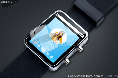 Image of close up of smart watch with music player track