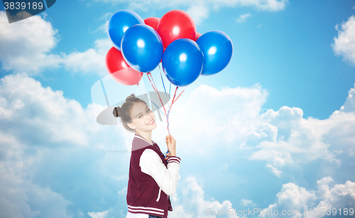 Image of happy teenage girl with helium balloons