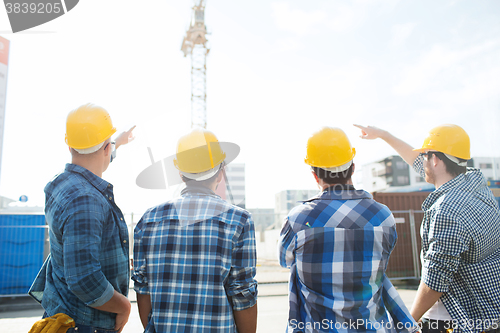 Image of group of builders in hardhats at construction site