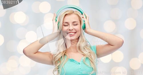 Image of happy young woman or teenage girl with headphones