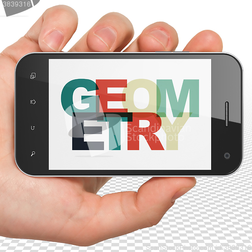 Image of Learning concept: Hand Holding Smartphone with Geometry on  display