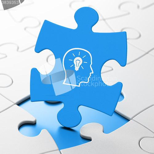 Image of Studying concept: Head With Lightbulb on puzzle background