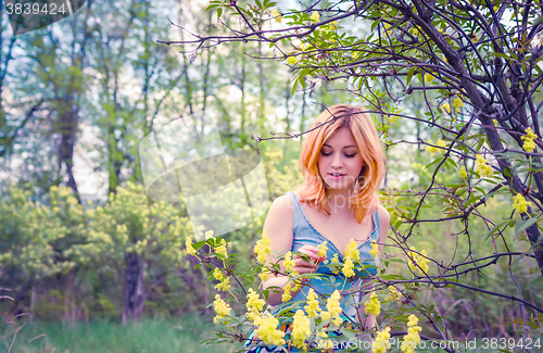 Image of Young woman in the spring garden