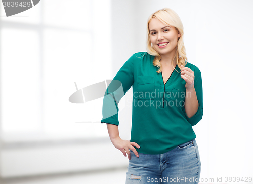 Image of smiling young woman in shirt and jeans