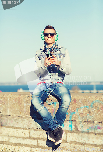 Image of happy young man with tablet pc and headphones