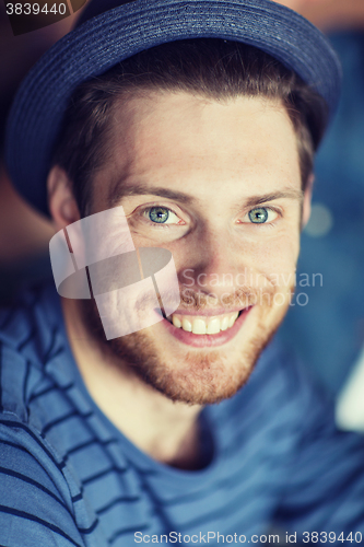 Image of happy young man in hipster hat