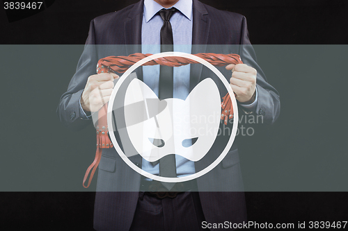 Image of man in business suit with chained hands. handcuffs for sex games. concept of erotic entertainment.