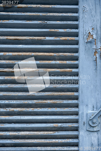 Image of rundown blue shutter