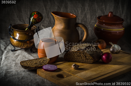 Image of Still life with homemade bread and pottery