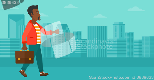 Image of Businessman walking with briefcase. 