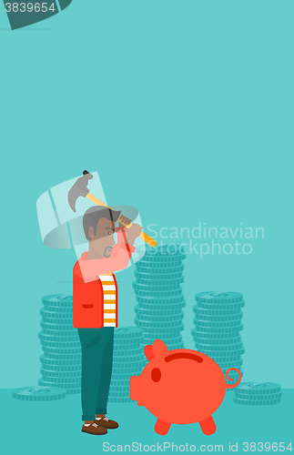 Image of Man breaking piggy bank.