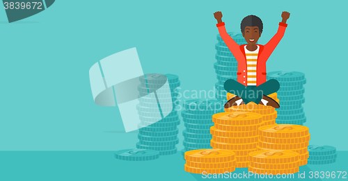 Image of  Happy businessman sitting on coins.