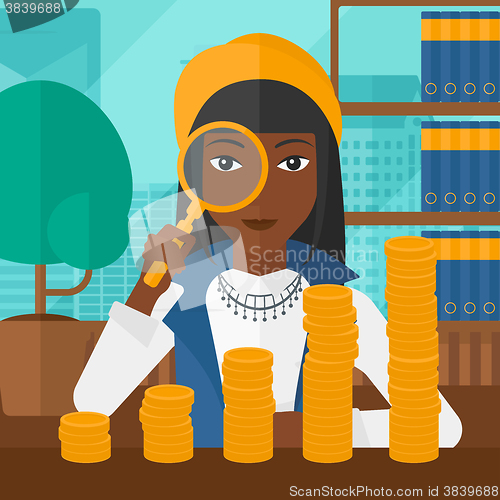 Image of Woman with magnifier and golden coins. 