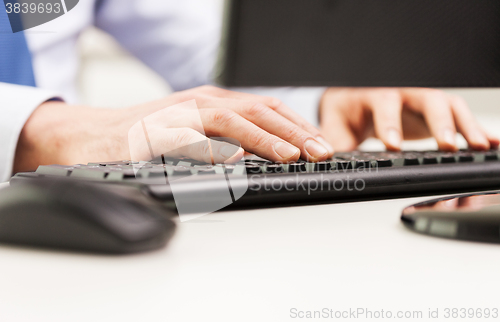 Image of close up of businessman hands typing on keyboard