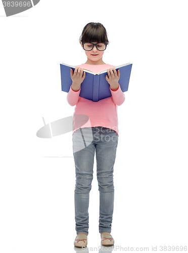 Image of happy little girl in eyeglasses reading book