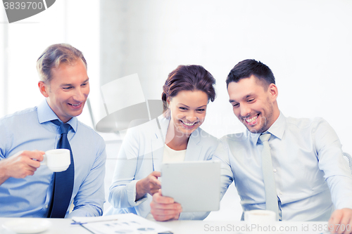 Image of business team having fun with tablet pc in office