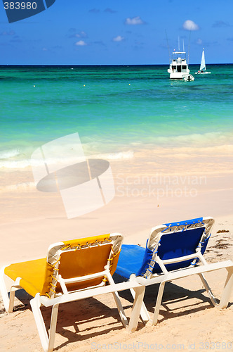 Image of Chairs on sandy tropical beach