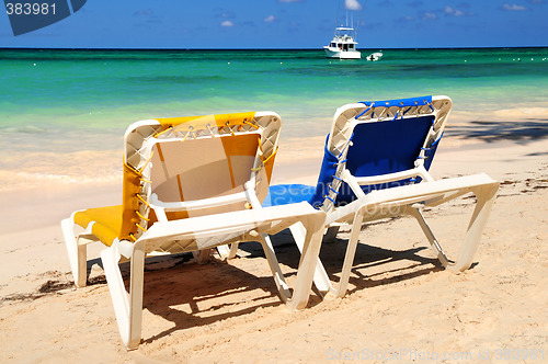 Image of Chairs on sandy tropical beach