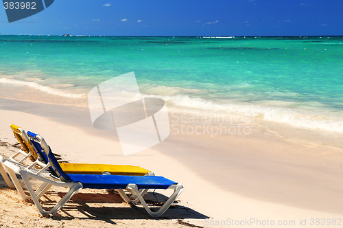 Image of Chairs on sandy tropical beach