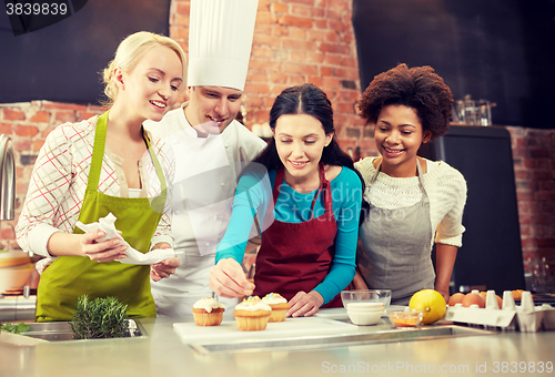 Image of happy women and chef cook baking in kitchen