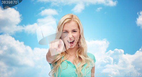 Image of happy young woman pointing finger to you