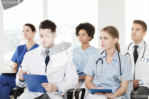 Image of group of happy doctors on seminar at hospital