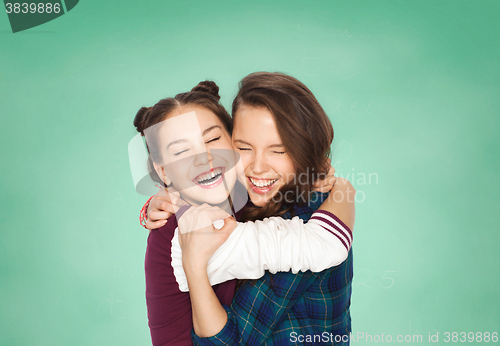 Image of happy smiling teenage student girls hugging