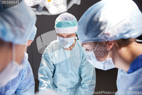 Image of group of surgeons in operating room at hospital