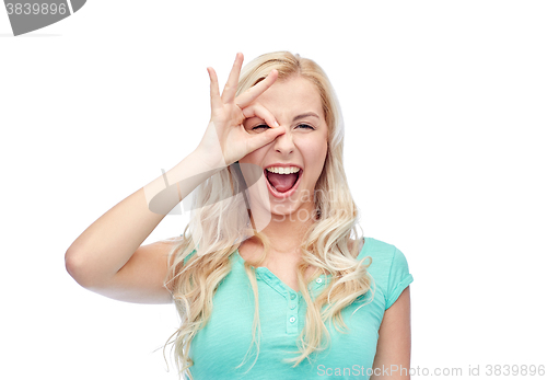 Image of young woman making ok hand gesture