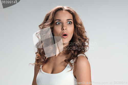 Image of Portrait of young woman with shocked facial expression