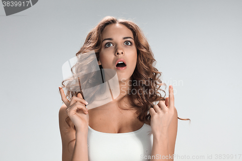 Image of Portrait of young woman with shocked facial expression