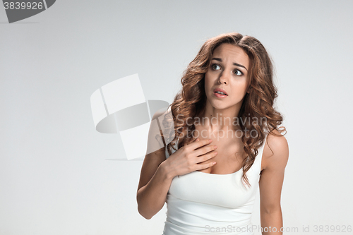 Image of Woman is looking imploring over gray background