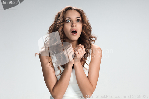 Image of Portrait of young woman with shocked facial expression