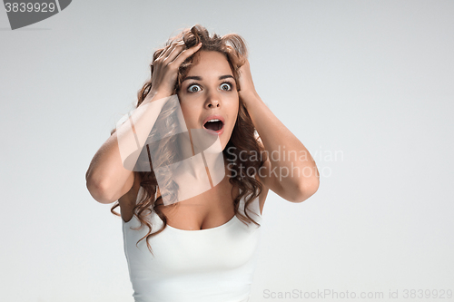 Image of Portrait of young woman with shocked facial expression