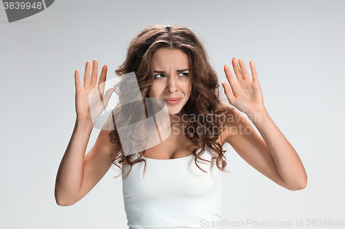 Image of Portrait of young woman with shocked facial expression