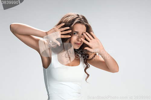 Image of The young woman\'s portrait with frightened emotions